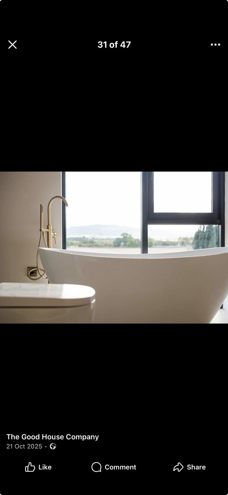 Freestanding bath with countryside view