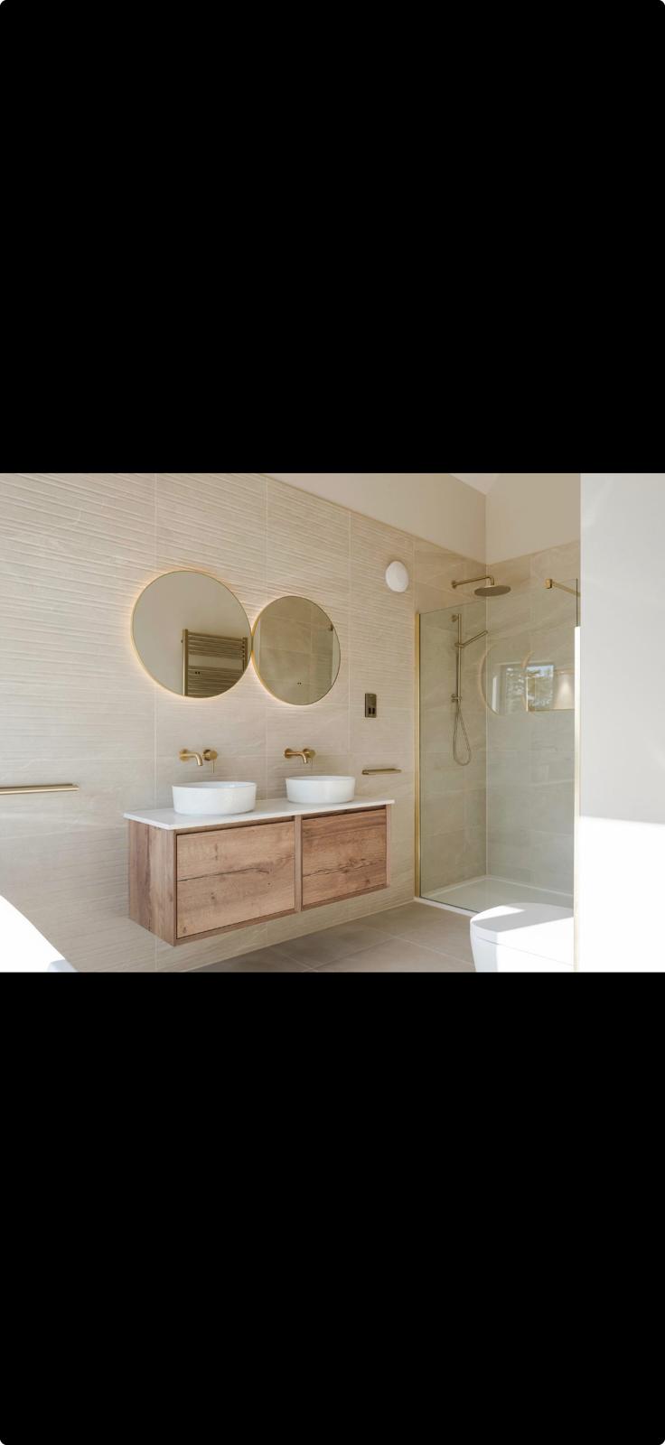 Modern bathroom installation with twin sinks and walk-in shower